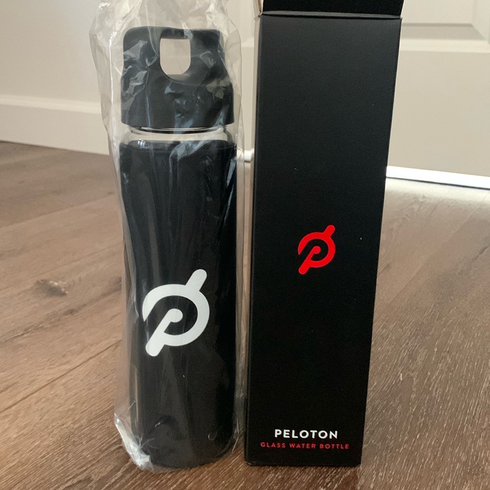 Peleton New Glass Water Bottle with Black Silicon Wrap 16 Oz capacity.